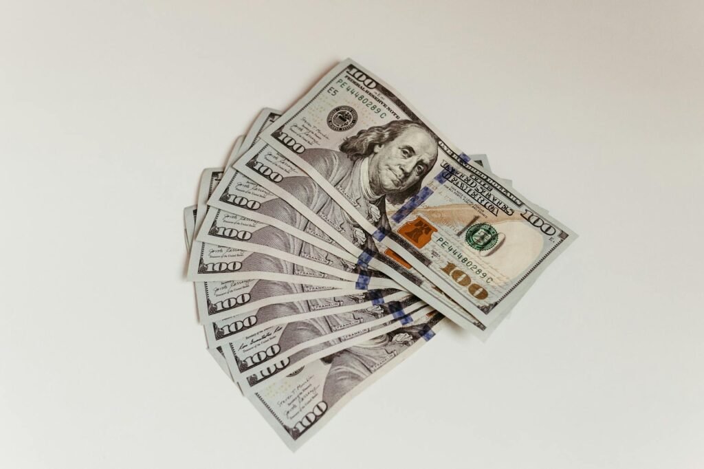 Stack of hundred dollar bills representing investing one million dollars